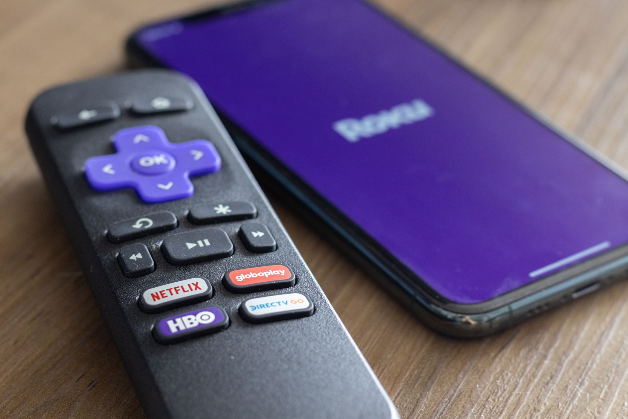 کنترلر تلویزیون Roku در کنار تلفن هوشمند