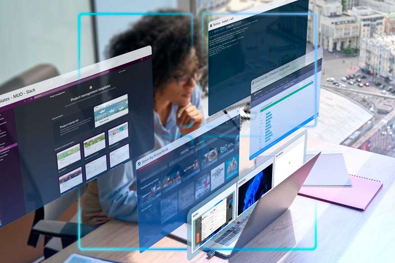 یک زن در دفتر کار با لپ‌تاپ خود و چندین دسکتاپ مجازی