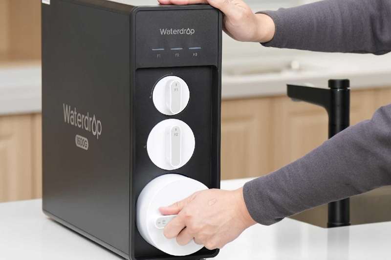 A Person Adjusting the Filters of the Waterdrop X16 RO System