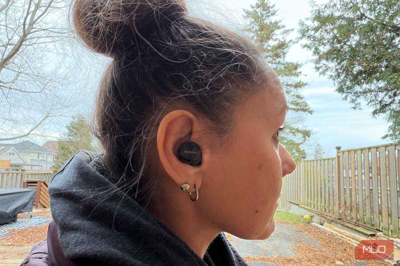 زنکی بیرون که هدفون‌های پاناسونیک تکنیکز EAH‑AZ100 را بر گوش دارد.