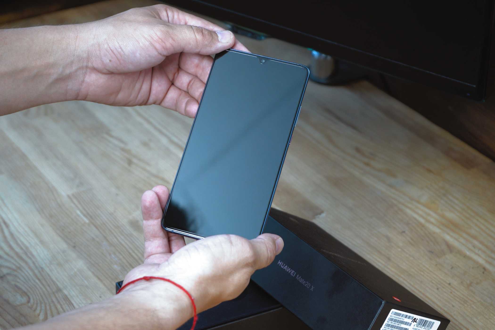 آدمی که گوشی اندروید را در دست دارد و سعی میکند آن را روشن کند