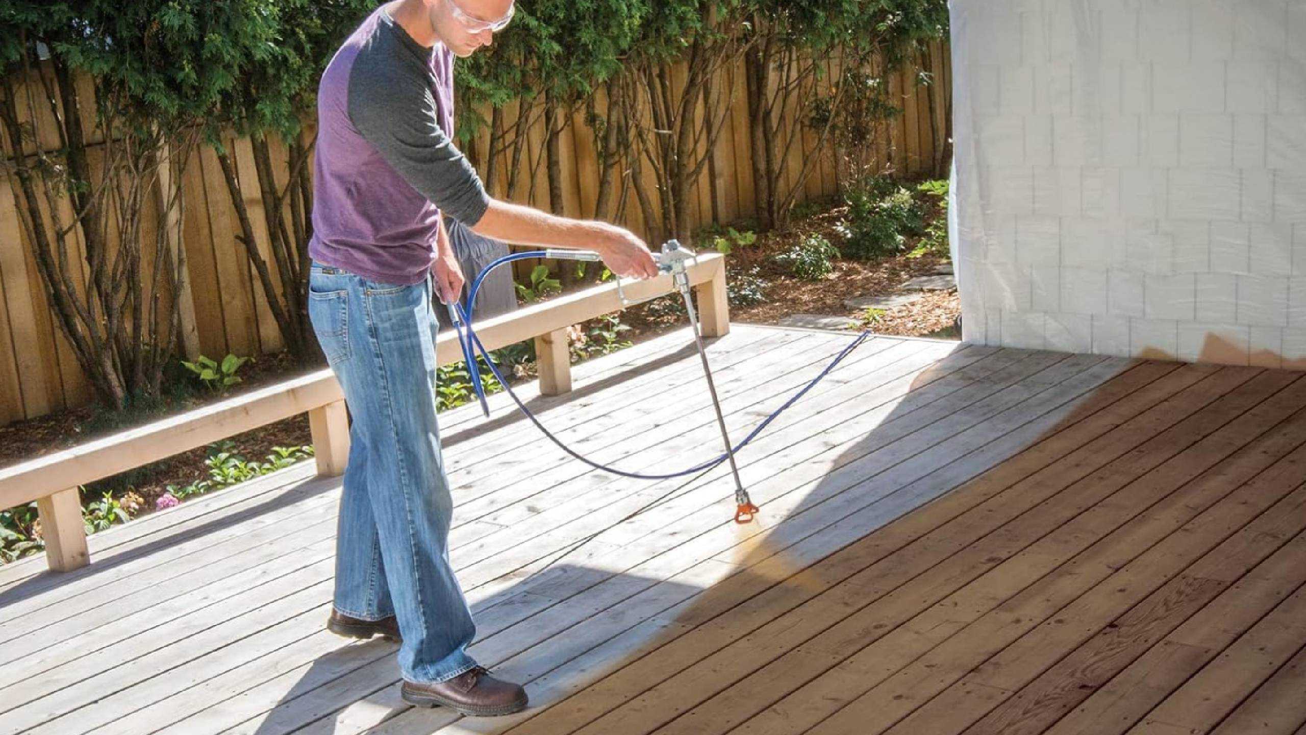 شخصی که از اسپری رنگ Graco Magnum روی عرشهٔ خود استفاده می‌کند