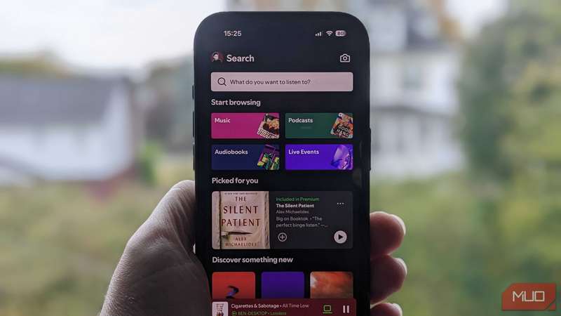 صفحه اصلی Spotify بر روی یک iPhone در مقابل پنجره