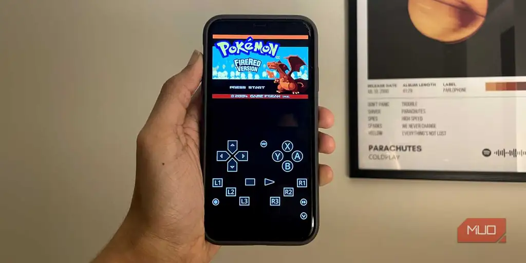 اجرای Pokémon FireRed با RetroArch روی iPhone در کنار پوستر Coldplay