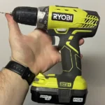 A RYOBI ONE holding in front of a fridge