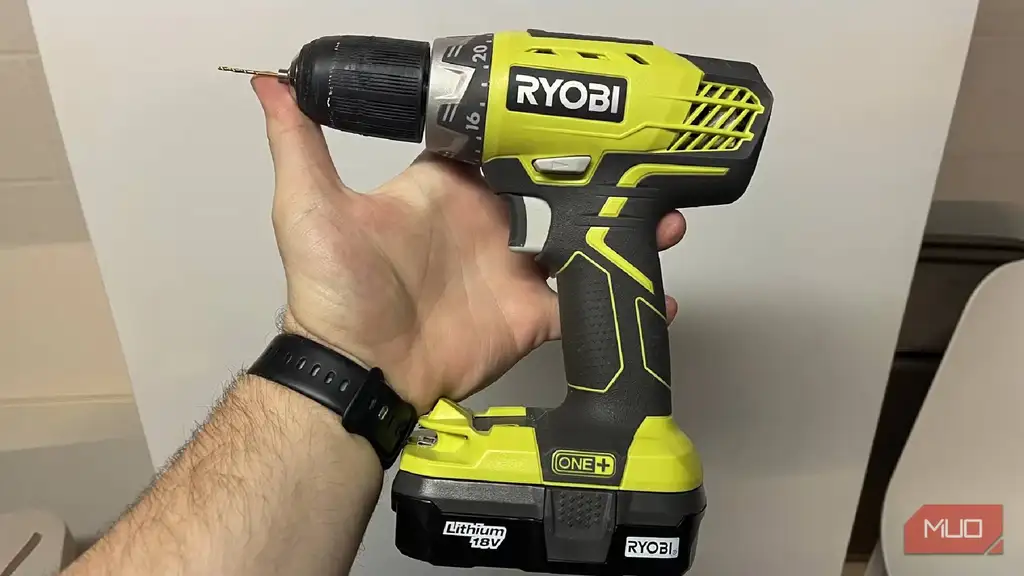 A RYOBI ONE holding in front of a fridge