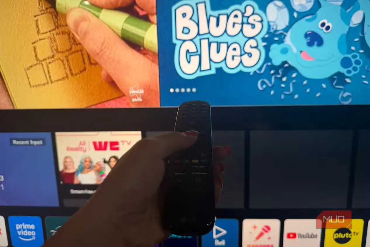 دستی که LG Magic Remote را جلوی تلویزیون LG نگه داشته است