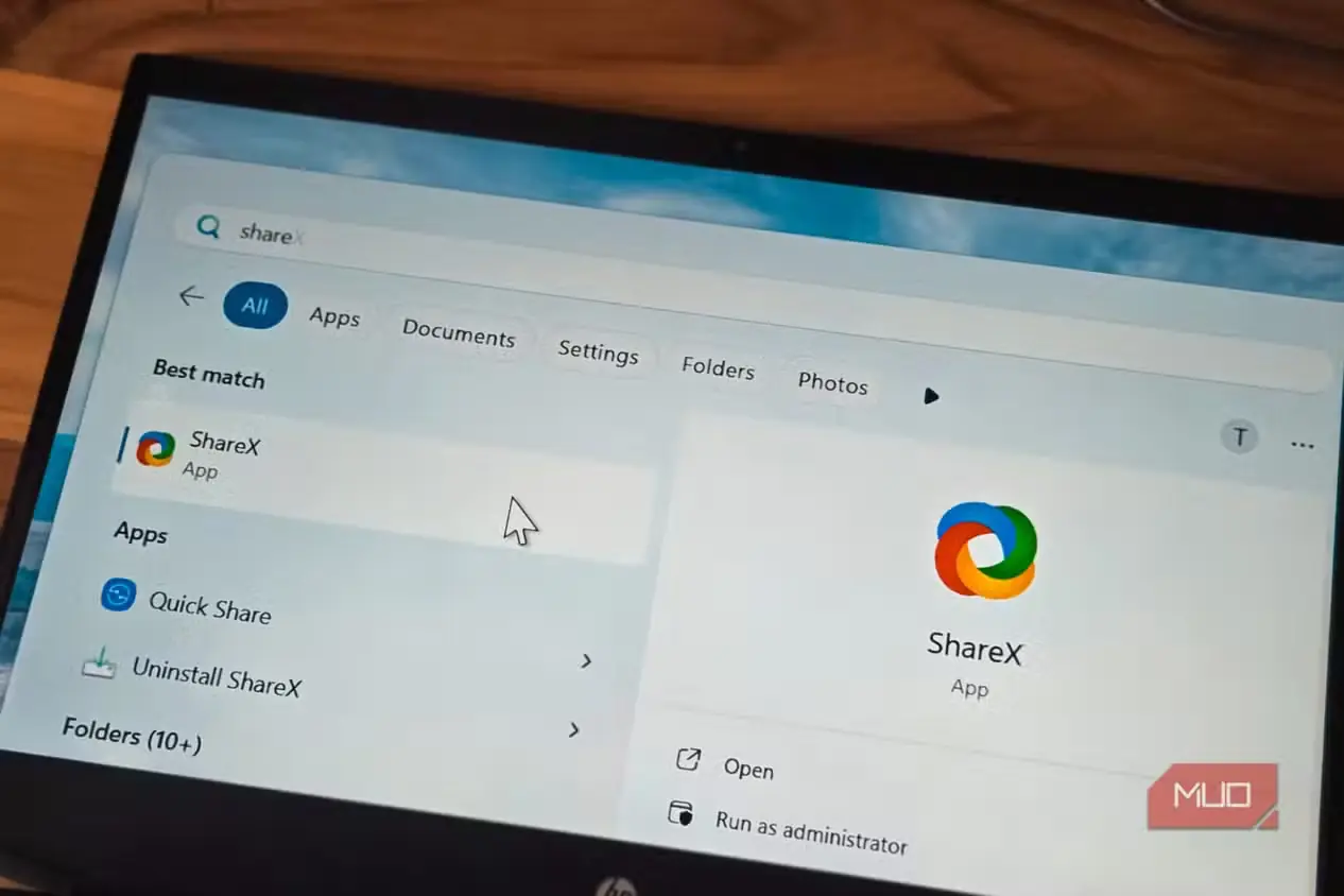 لوگوی برنامه ShareX باز شده روی صفحه لپتاپی که روی یک میز قرار دارد